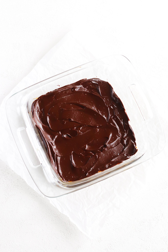 No-bake Chocolate-Frosted Paleo Pumpkin Brownies in a glass 8x8 baking dish.